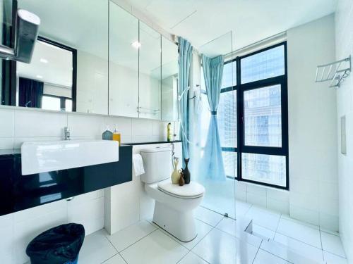 a bathroom with a toilet and a sink and a window at W 1-10Pax Trefoil 2Room Cozy Home WifiTV SetiaAlam in Setia Alam