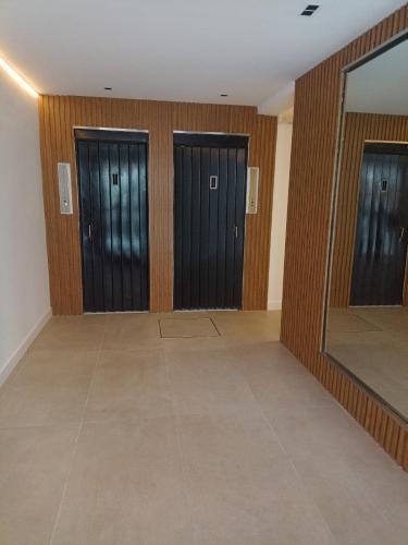 a room with three doors and a mirror at AGRADABLE STUDIO EN PALERMO in Buenos Aires
