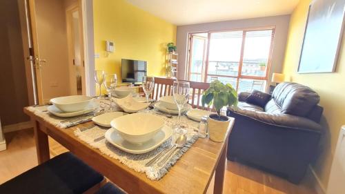 a dining room table with plates and glasses on it at 12 Courthouse Square in Clifden