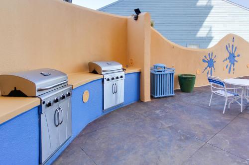 a patio with two stoves and a table and chairs at Splash Beach Resort by Panhandle Getaways in Panama City Beach