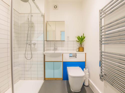 a bathroom with a toilet and a sink and a shower at Pass the Keys Peckham House with garden London in London