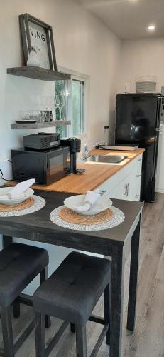 a kitchen with a table with chairs and a counter top at Stunning Modern Container Home on Golden Lake in Killaloe Station