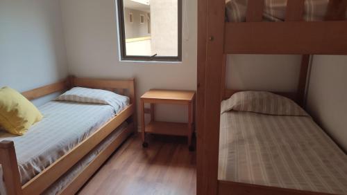 a bedroom with two bunk beds and a mirror at Club Playa Blanca in Playa Blanca