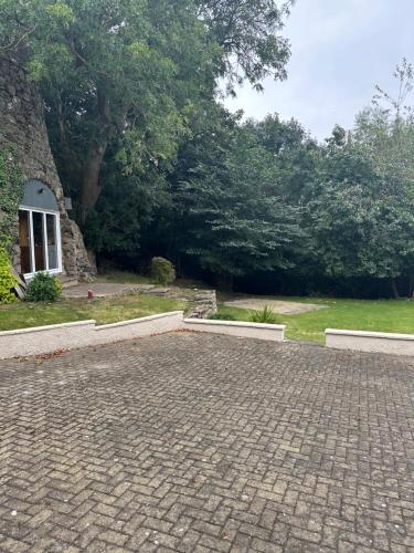 a brick driveway in front of a yard with trees at Cameron Coach House Modern Property in Murrayfield Edinburgh in Edinburgh