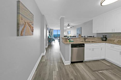 a kitchen with white cabinets and a counter top at Destin on the Gulf 404 - Amazing Views just Steps away from the Beach in Destin