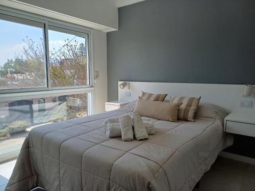 a bedroom with a large bed with a large window at Departamento de un dormitorio - JUJUY in Santa Fe