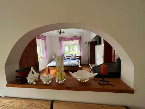 an archway in a room with a room with a bed at Vila Kučera in Chřibská