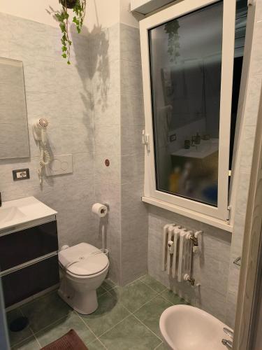 a small bathroom with a toilet and a sink at Relax room Apartment in Rome