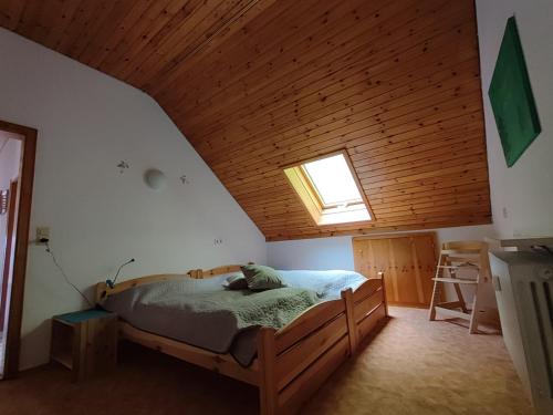 a bedroom with a bed and a wooden ceiling at Feldbergsicht in Lenzkirch