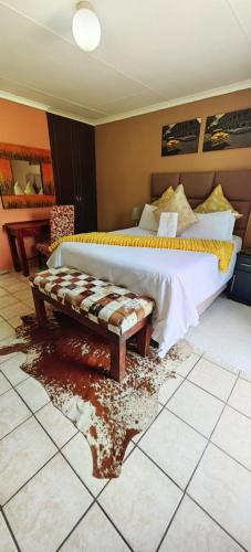 a bedroom with a bed and a dirty floor at Mthandi Wokuhamba Lodge in Dundee