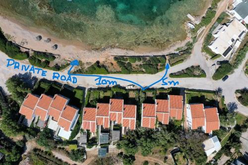 arial view of a house on a beach with a map at Sounio - Waterfront Luxury Spa Villa Pounta Zeza 170 sqm on Private Beach in Sounio
