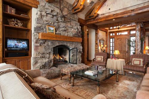 a large living room with a stone fireplace at 866 Bachelor Ridge in Edwards