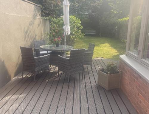 a patio with a table and chairs on a deck at Fashionable Chic Townhouse in D4 in Dublin