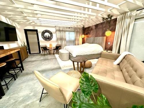 a living room with a couch and a bed at Zen.Modern.Hip “Studio 501” Beach,Scuba,Downtown in West Palm Beach