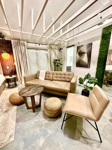 a living room with a couch and a table and chairs at Zen.Modern.Hip “Studio 501” Beach,Scuba,Downtown in West Palm Beach