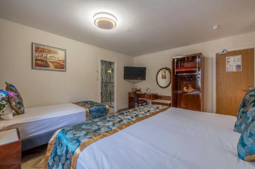a hotel room with two beds and a tv at Muthu Fort William Hotel in Fort William