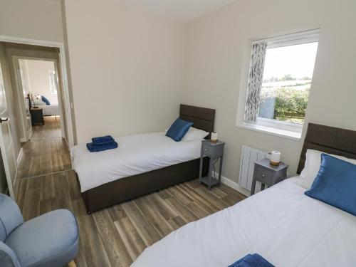 a bedroom with two beds and a window at Southend in Welland