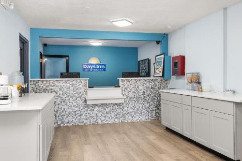 a dental office with a waiting room with blue walls at Days-Inn by Wyndham Albuquerque I-25 in Albuquerque
