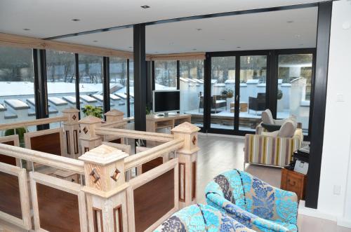 a living room with glass windows and a tv at Villa Tusculum in Binz in Binz