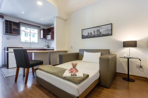 a bedroom with a bed and a table and a chair at Mercure Sao Paulo JK in Sao Paulo