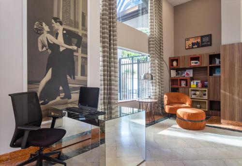 a living room with a dance picture on the wall at Mercure Sao Paulo JK in Sao Paulo