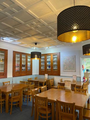 a dining room with wooden tables and chairs at YHA Windermere in Troutbeck