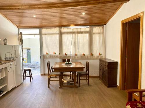 a kitchen with a table and chairs and a refrigerator at Cozy 3-BR Getaway, Lama de Arcos by LovelyStay 