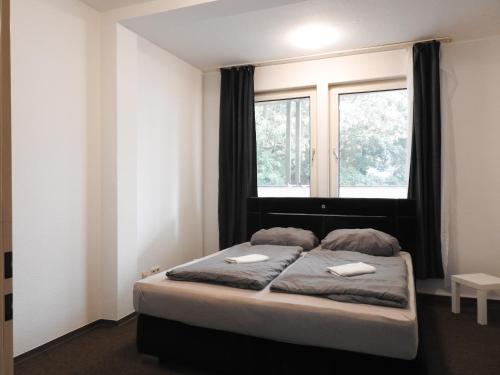 a bedroom with a large bed with a window at Kapitän Dallmann str.14 in Bremen