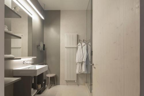 a bathroom with a shower and a sink and a mirror at Casa de São Lourenço - Burel Panorama Hotel - member of Design Hotels in Manteigas
