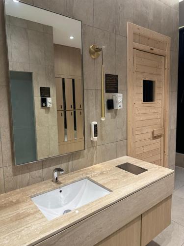 a bathroom with a sink and a mirror at KLCC Suites At Axon Residence in Kuala Lumpur