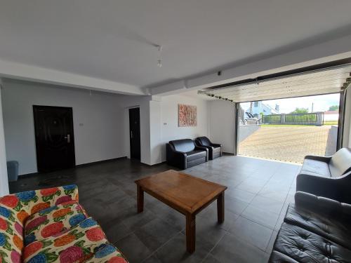 a living room with a couch and a coffee table at Casa Elisabeta in Bilca
