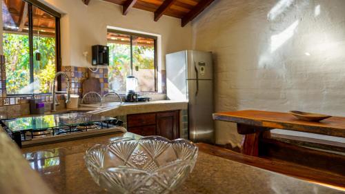 a kitchen with a stainless steel refrigerator and a counter at Terra Coral - Chapada dos Veadeiros in Alto Paraíso de Goiás