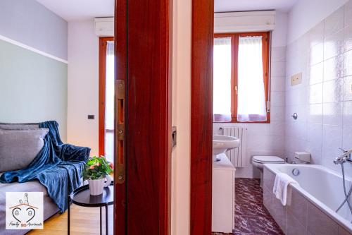a bathroom with a tub and a toilet and a sink at FamilyBO Apartments Sant'Orsola in Bologna