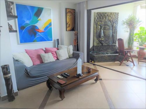 a living room with a couch and a table at Studio Viewtalay 3 Anastasiya in Pattaya South