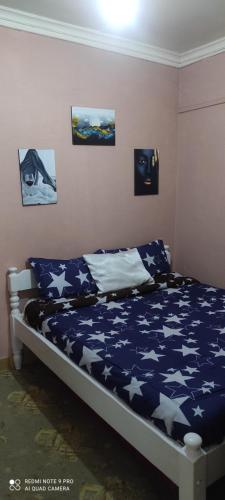 een slaapkamer met een bed met sterren erop bij Elegantly furnished 1bedroom at Claycity, Thika Rd in Nairobi