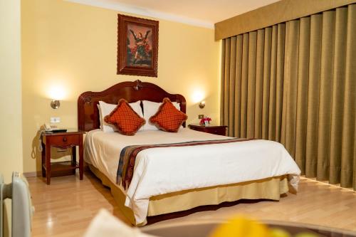 Rúm í herbergi á Hotel Agustos Cusco