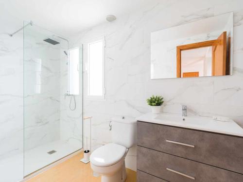 a bathroom with a toilet and a shower and a sink at Mahostly Corralejo Vista Mar in Corralejo