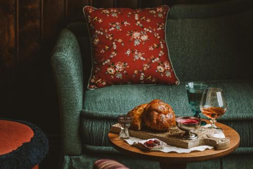a table with a turkey and a glass of wine on a chair at Le Grand Mazarin in Paris