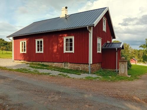 a red barn with a black roof at Amazing home in Gislaved with WiFi and 2 bedroom in Gislaved