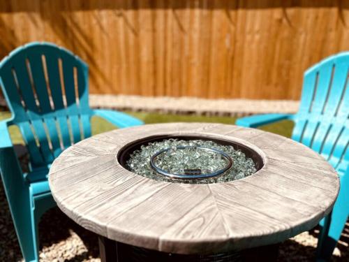 a wooden table with two blue chairs and a table with a plate at Boho Bliss in Chico