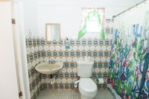 a bathroom with a toilet and a sink at La Casa de Vida Natural in Rio Grande