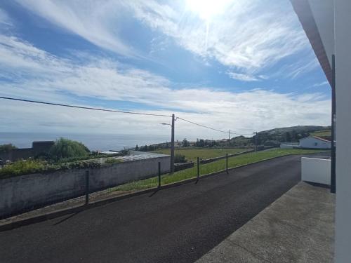 a road with a fence on the side of the road at OCEANVIEW in Lajes das Flores