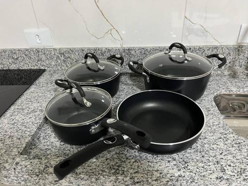 three pots and pans sitting on a kitchen counter at Apart Hotel Neri in Sinop