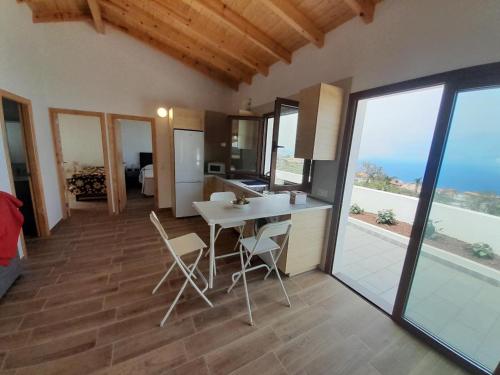 a kitchen and living room with a table and chairs at Villa La Casita. in La Matanza de Acentejo