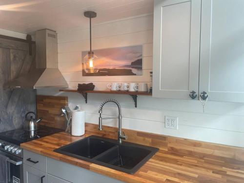 a kitchen with a sink and a counter top at Sunrise Loft - Beach front guest house in Sandspit