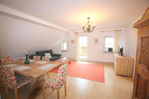 a living room with a wooden table and chairs at Wohnung Rudolf in Bad Ischl