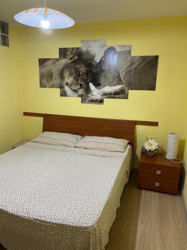 a bedroom with a bed and two pictures on the wall at Monolocale PIRILÙ in Reggio Calabria