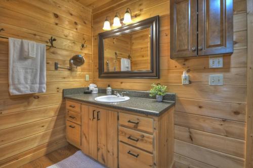 a bathroom with a sink and a mirror at ESCAPE & ENJOY HAVEN - Cabin with Game Room & Hot Tub in Blue Ridge