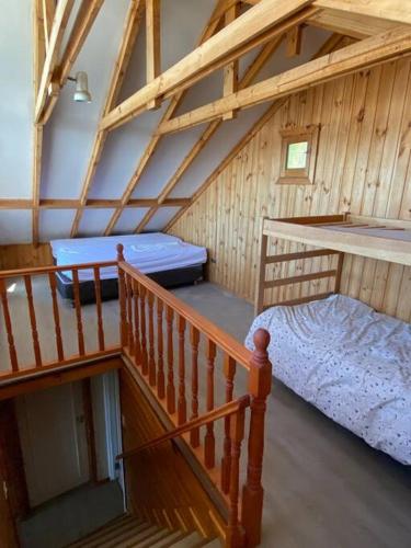 a attic room with a bunk bed and a staircase at Algarrobo Beach House Casa de Playa in Algarrobo