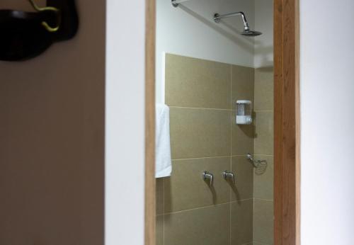 a bathroom with a shower with a glass door at Casa Moore in Medellín